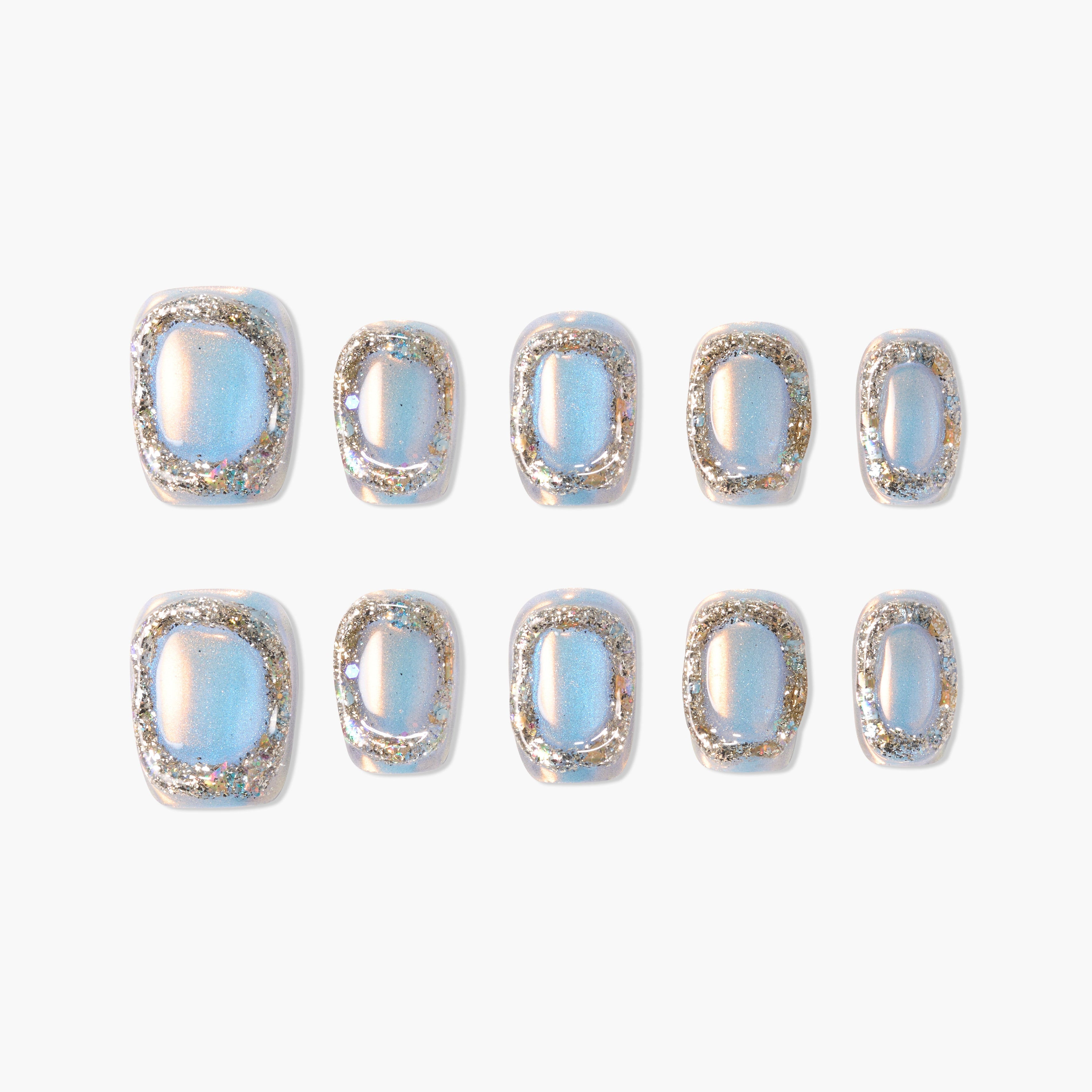 Set of blue iridescent press-on nails with silver glitter borders on white background