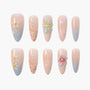 Set of 10 nude and pastel ombre press-on nails with floral designs and pearl accents