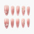 Set of pink ombre press-on nails with 3D floral accents, rhinestones, and pearl details