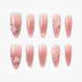 Set of pink ombre press-on nails with 3D floral accents, rhinestones, and pearl details