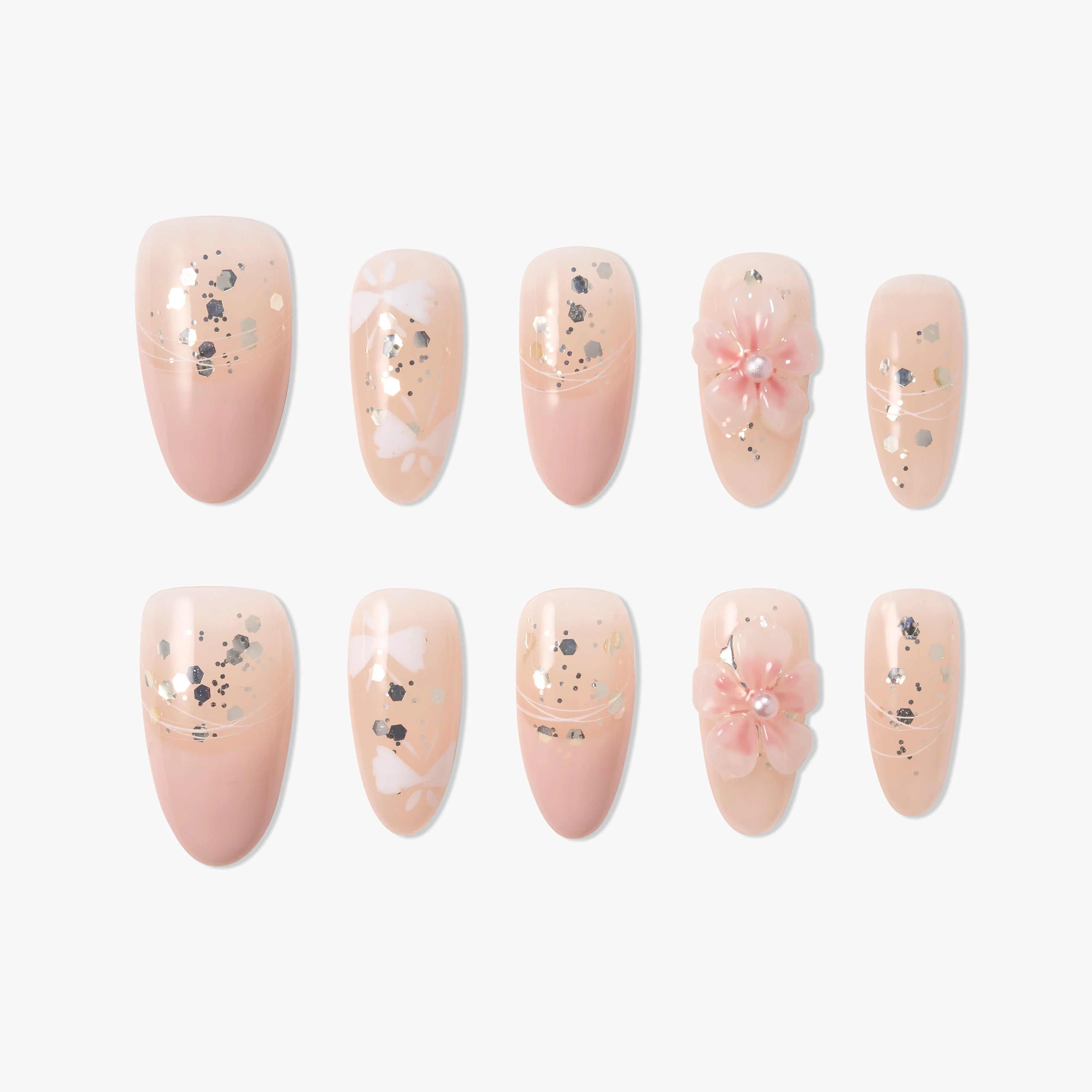 Set of nude press-on nails with silver glitter and 3D pink flower accents