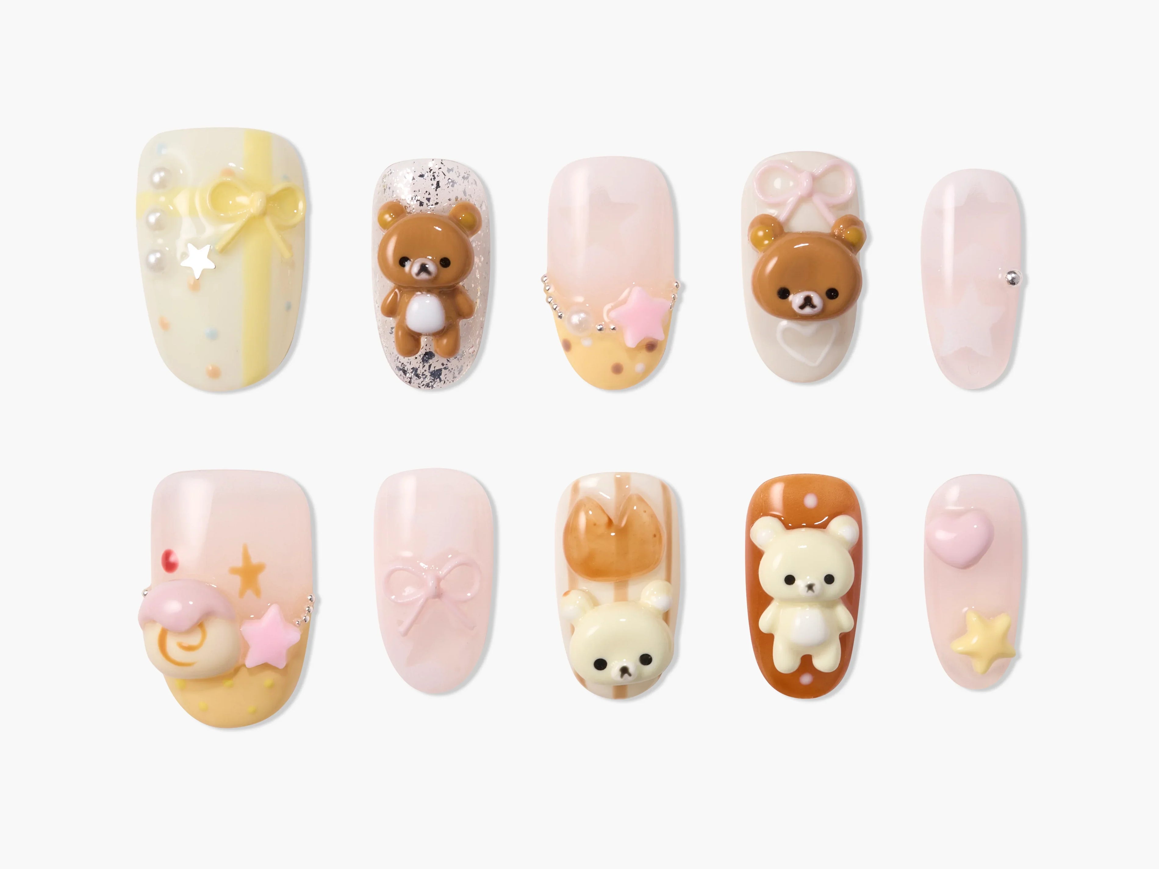 Handmade press-on nails with kawaii 3D bear, bow, and star designs in pastel colors