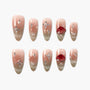 Handmade press-on nails with nude ombre, rhinestones, pearls, and ladybug 3D accents