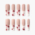 Matte nude press-on nails with red and beige lip print designs on white tips