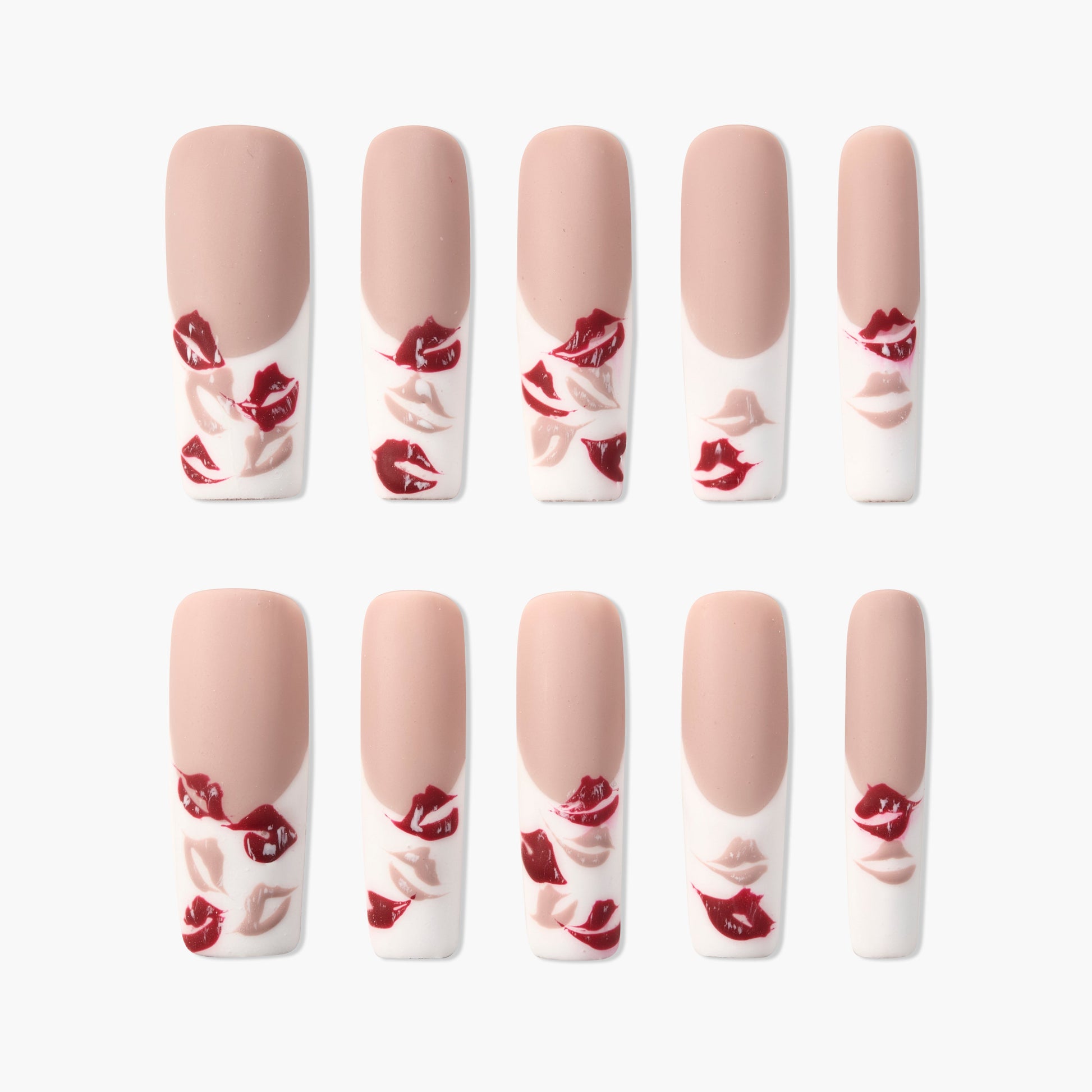Matte nude press-on nails with red and beige lip print designs on white tips