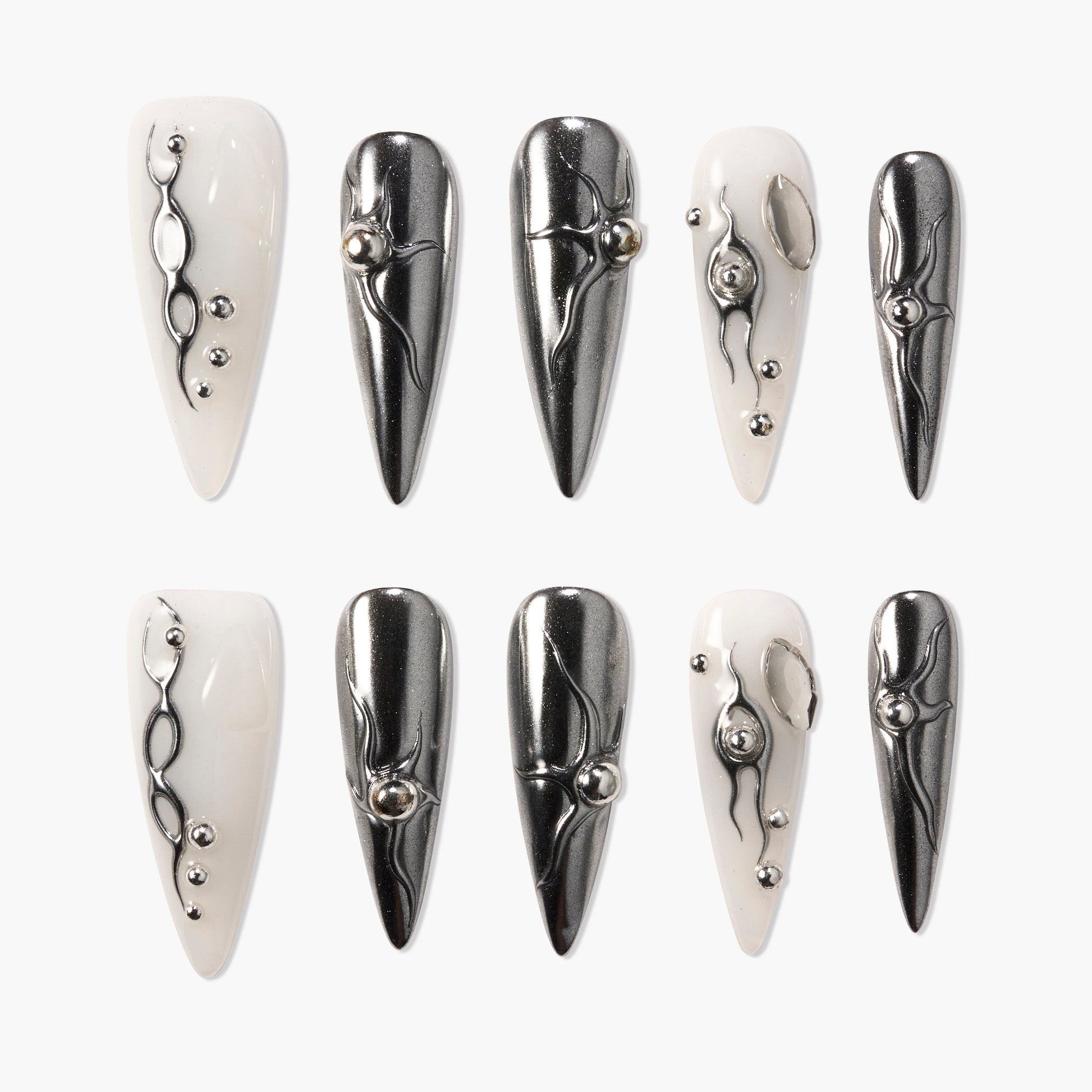 Long stiletto press-on nails in glossy white and metallic silver with 3D abstract accents