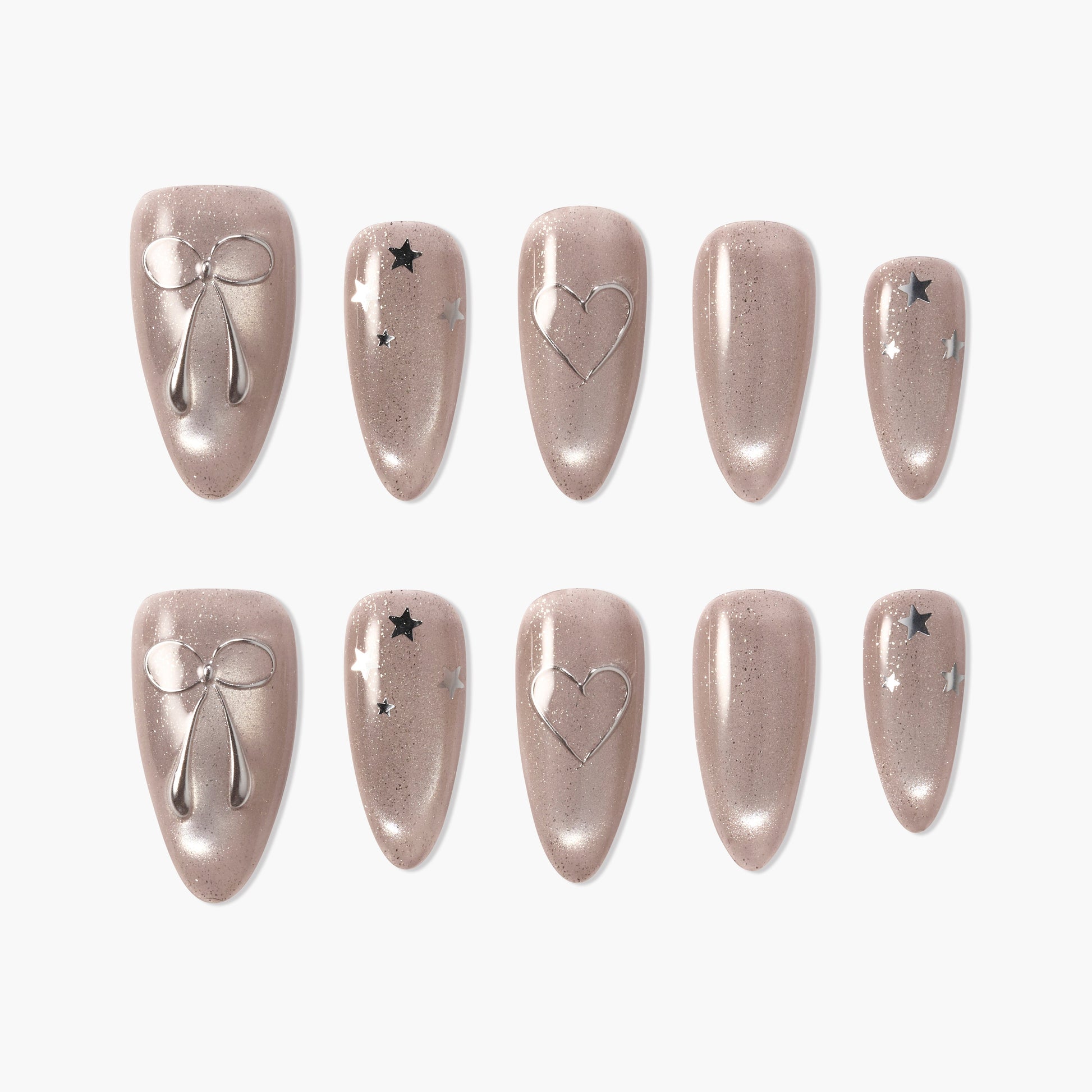 Set of sparkly nude press-on nails featuring silver bow, heart, and star designs