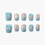 Handmade press-on nails with blue ombre, 3D blue bows, and rhinestone accents