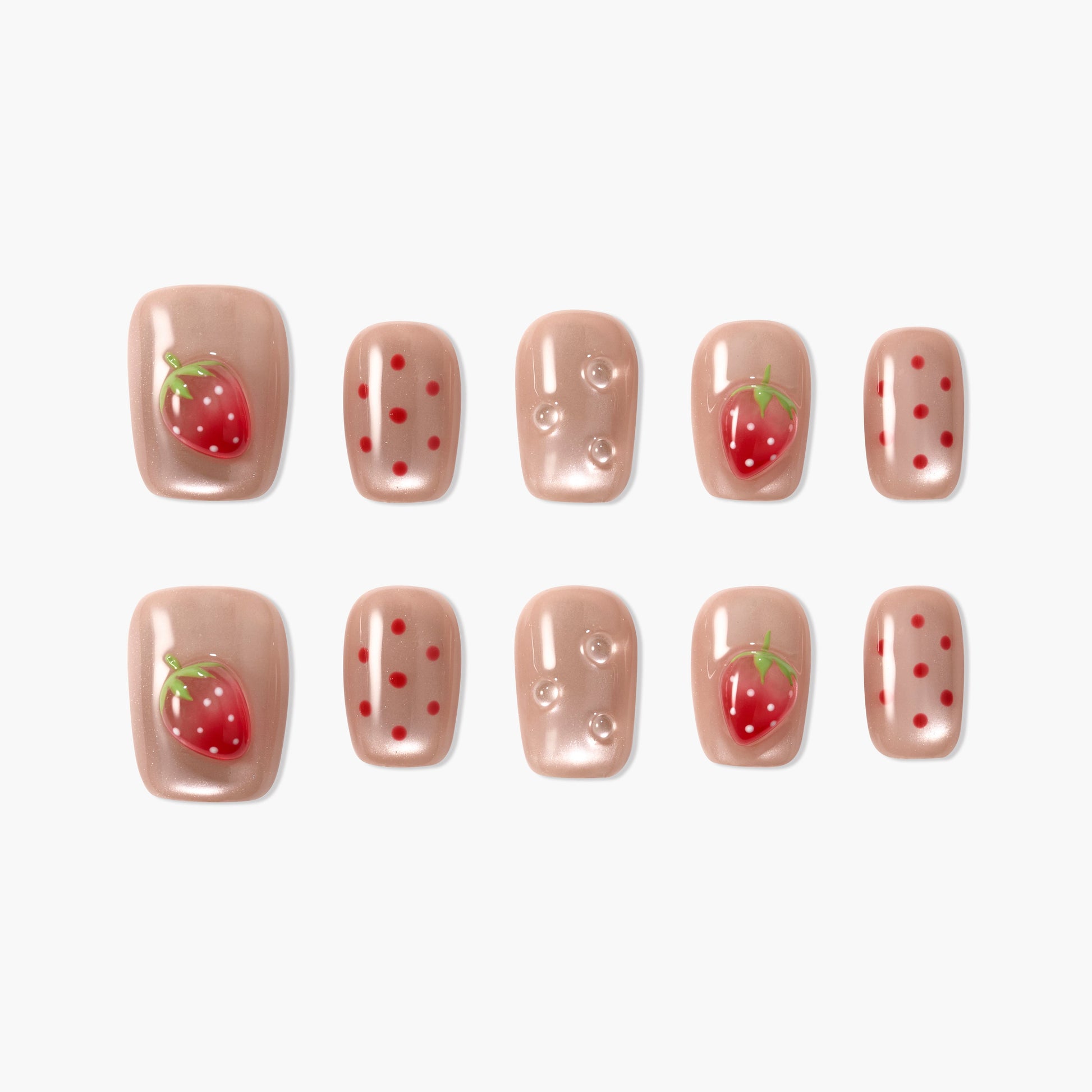Handmade press-on nails with nude base, red strawberry art, polka dots, and gem accents.