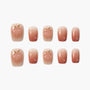 Set of nude ombre press-on nails with glossy 3D peach and droplet designs