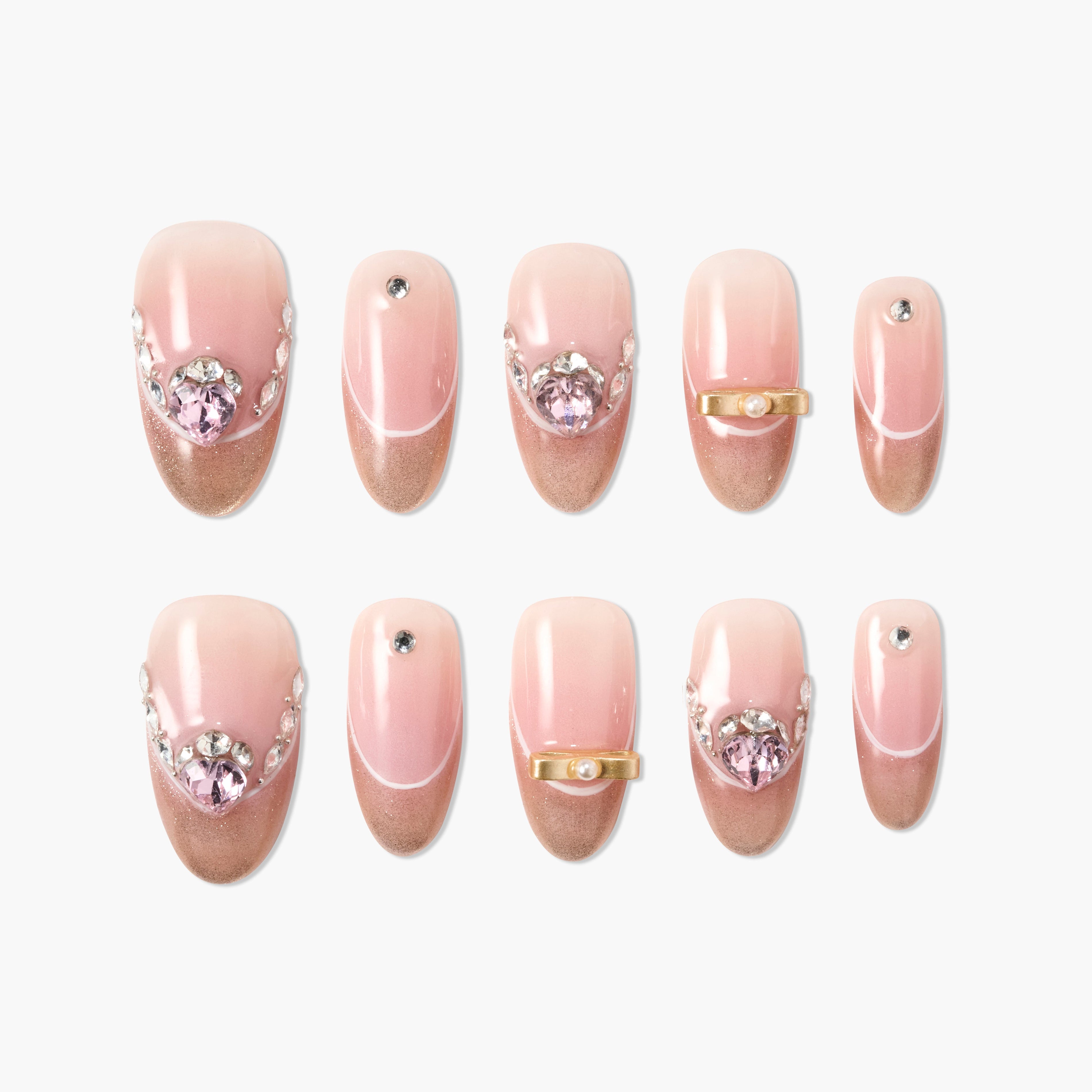 Set of pink ombre press-on nails with rhinestones and pearl embellishments on white background