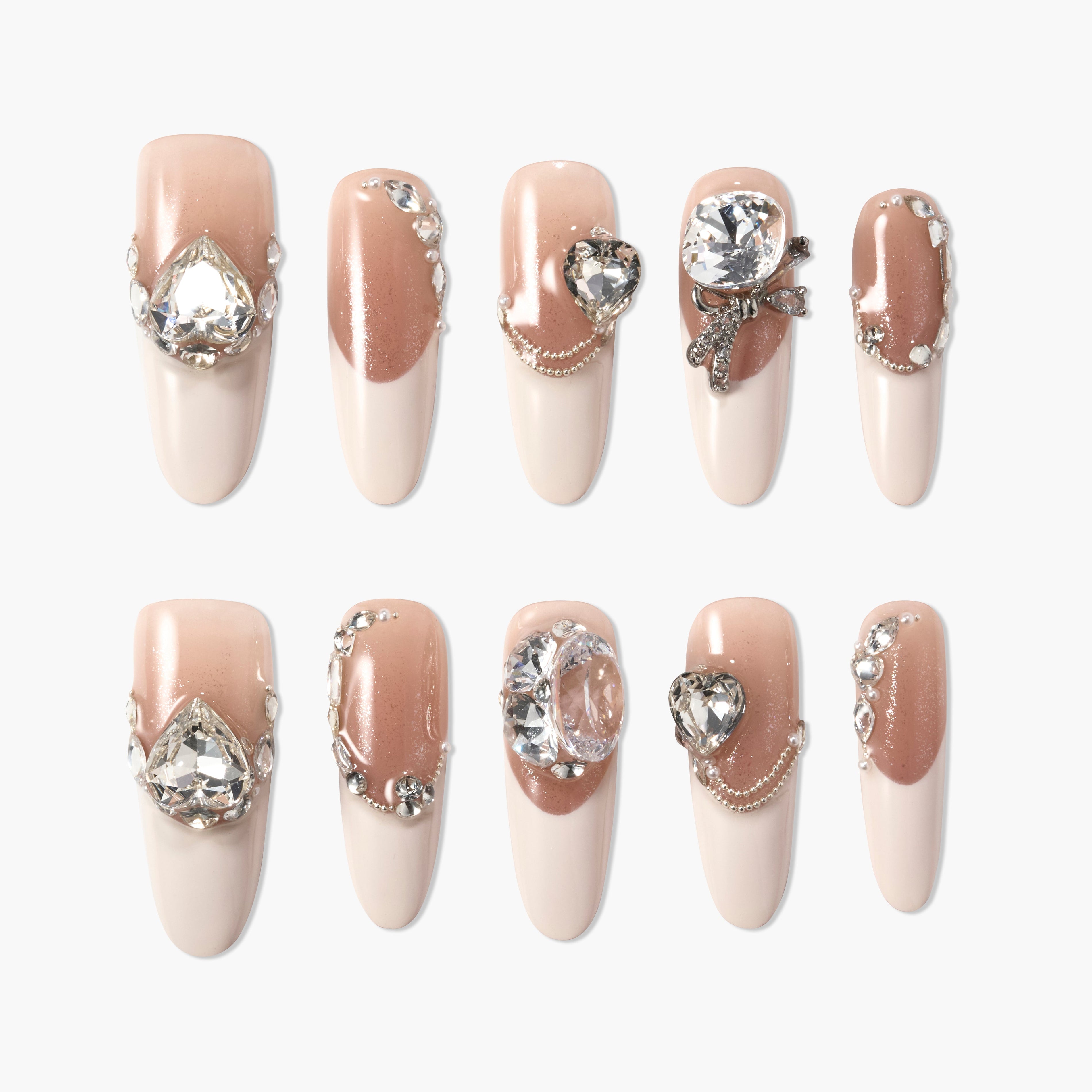 Set of nude pink press-on nails with sparkling rhinestones and elegant gem embellishments