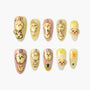 Set of press-on nails with cute bunny designs in yellow and pink tones, decorated with gems