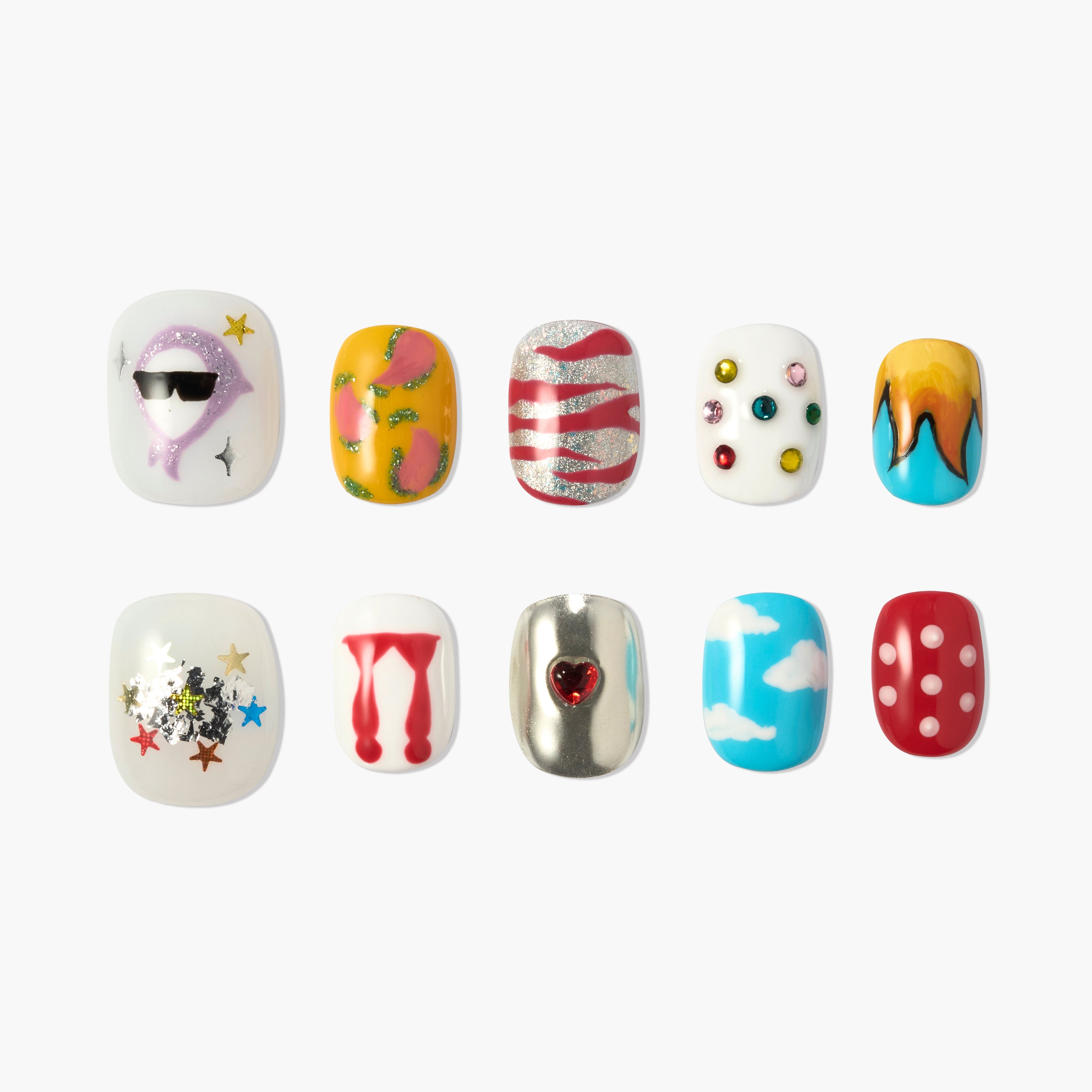 Colorful press-on nails with unique designs including sunglasses face, fruit, stripes, gems, flames, stars, dripping, heart, clouds, and polka dots