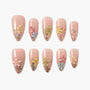 Handmade press-on nails with nude base, 3D floral designs, colorful gems, and glitter accents
