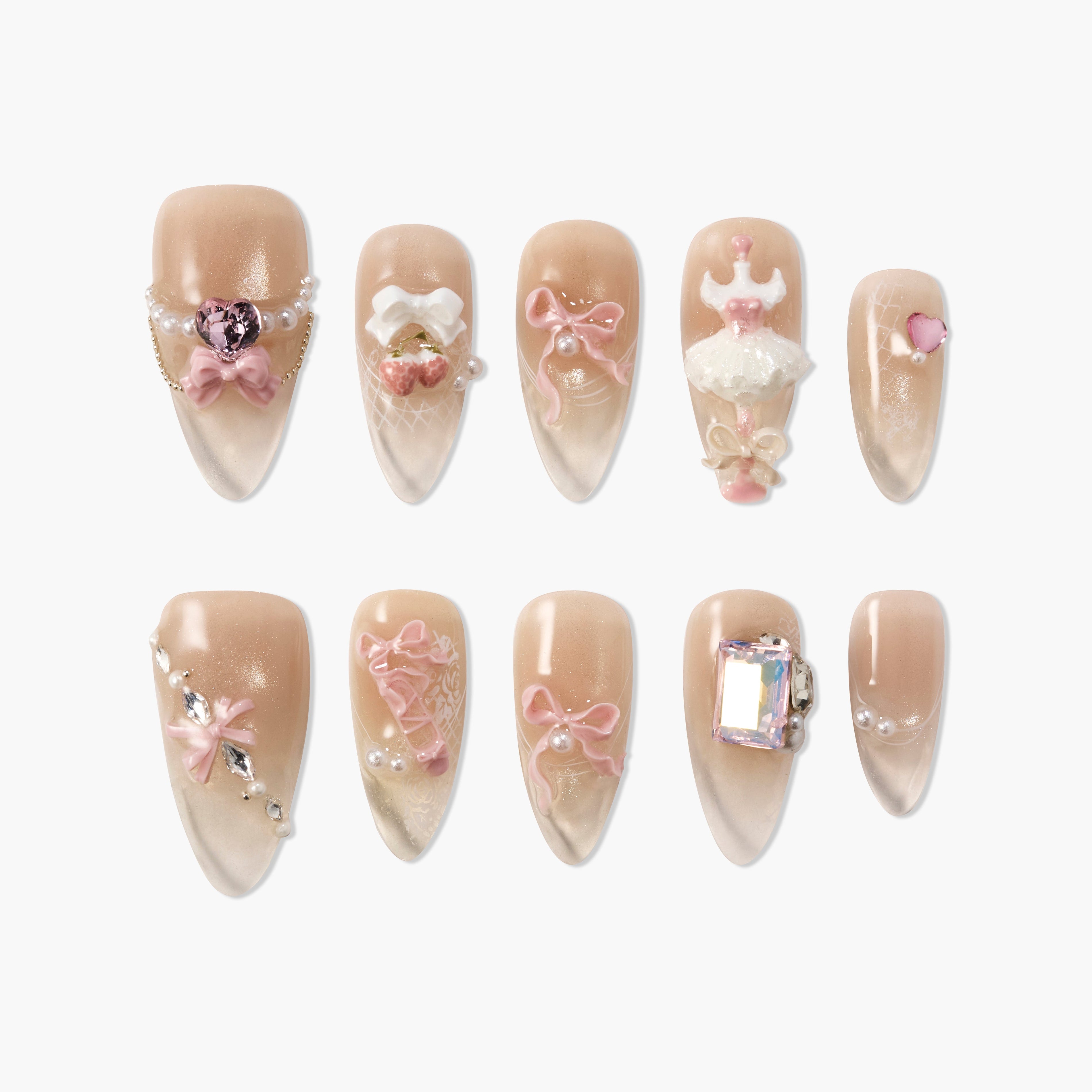 Set of nude pink press-on nails with 3D bows, pearls, heart, cherries, ballerina dress, and rhinestone decor