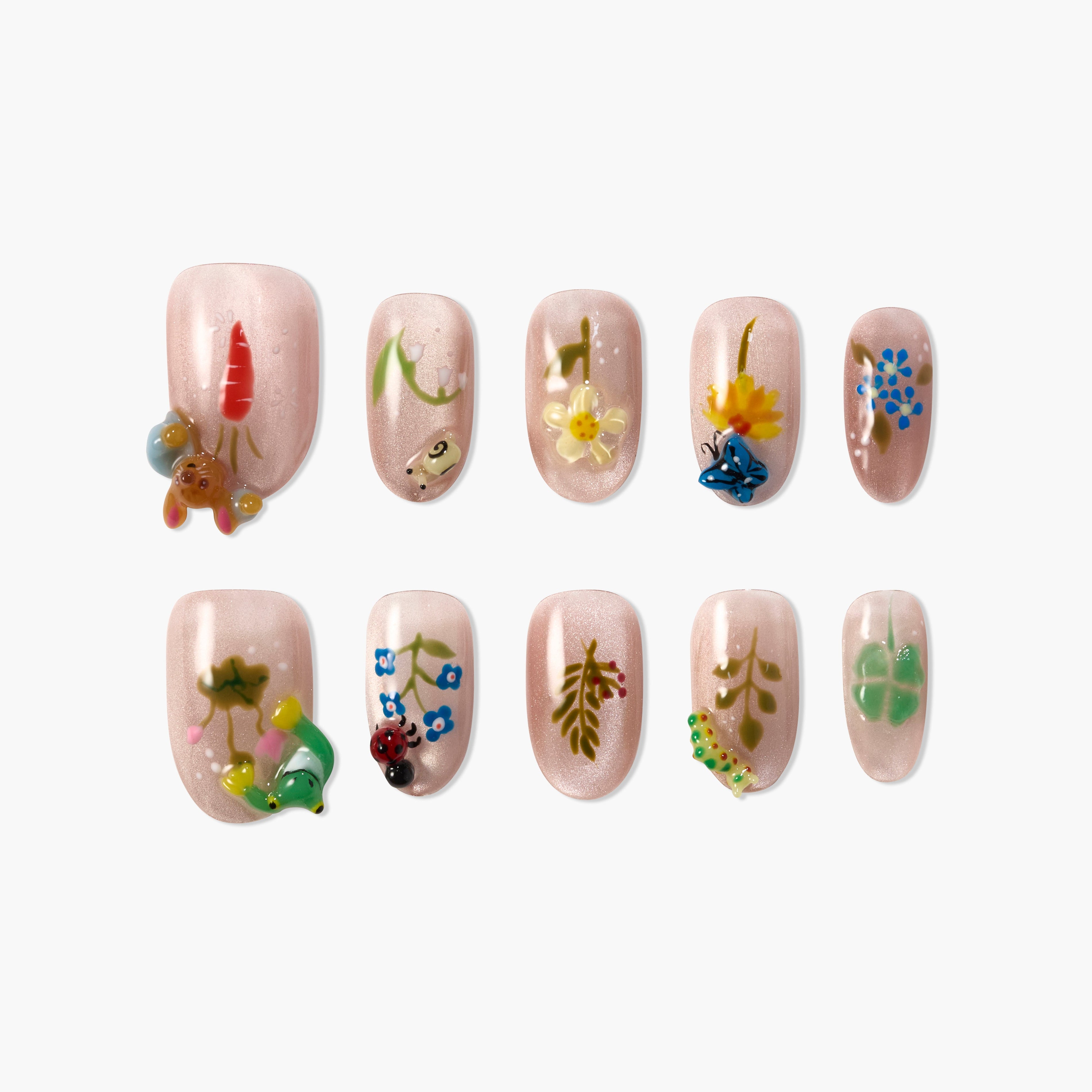 Set of pink shimmer press-on nails with 3D nature designs including flowers, carrot, caterpillar, butterfly, and ladybug