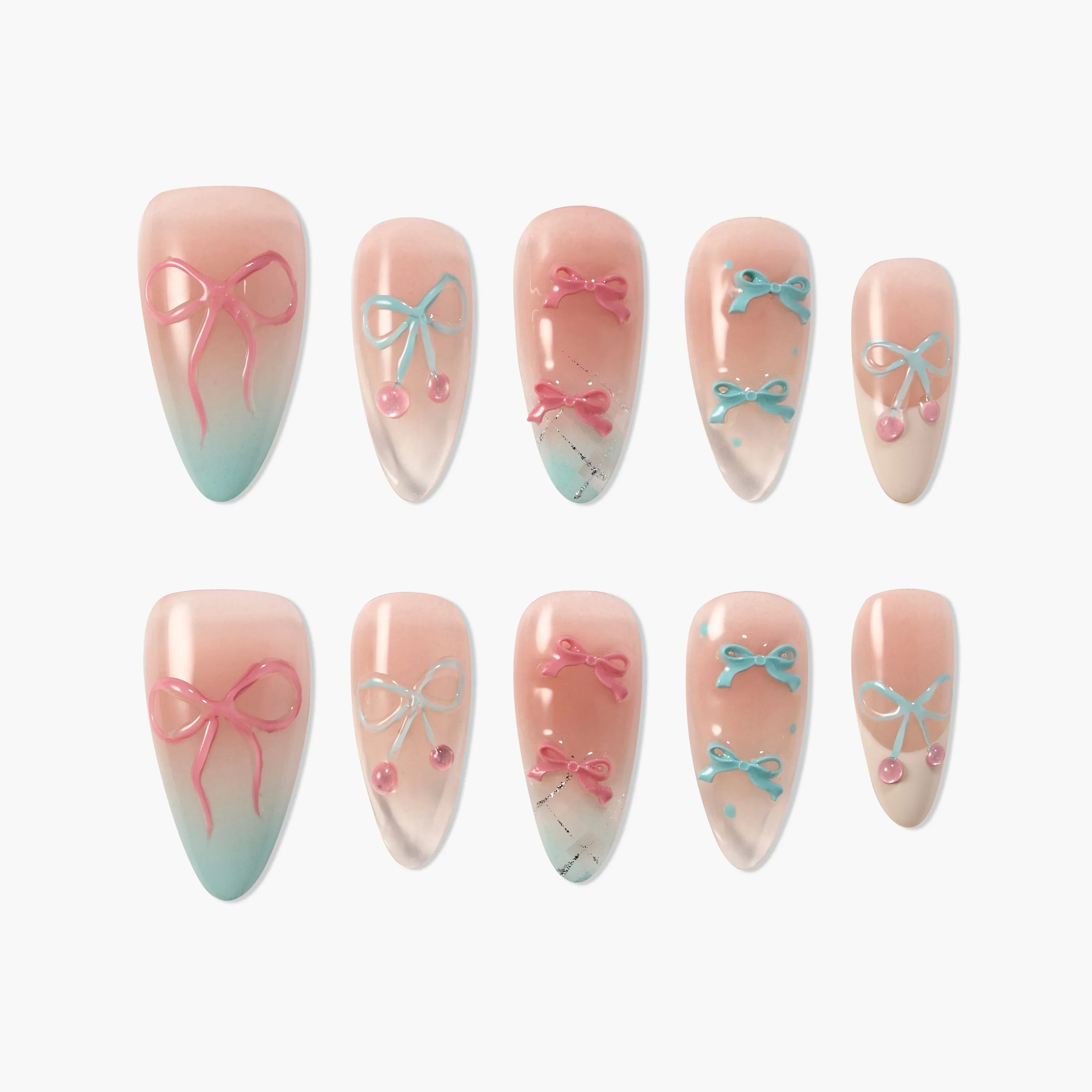 Set of press-on nails with pastel pink and blue bows, gradient ombre, and cherry designs