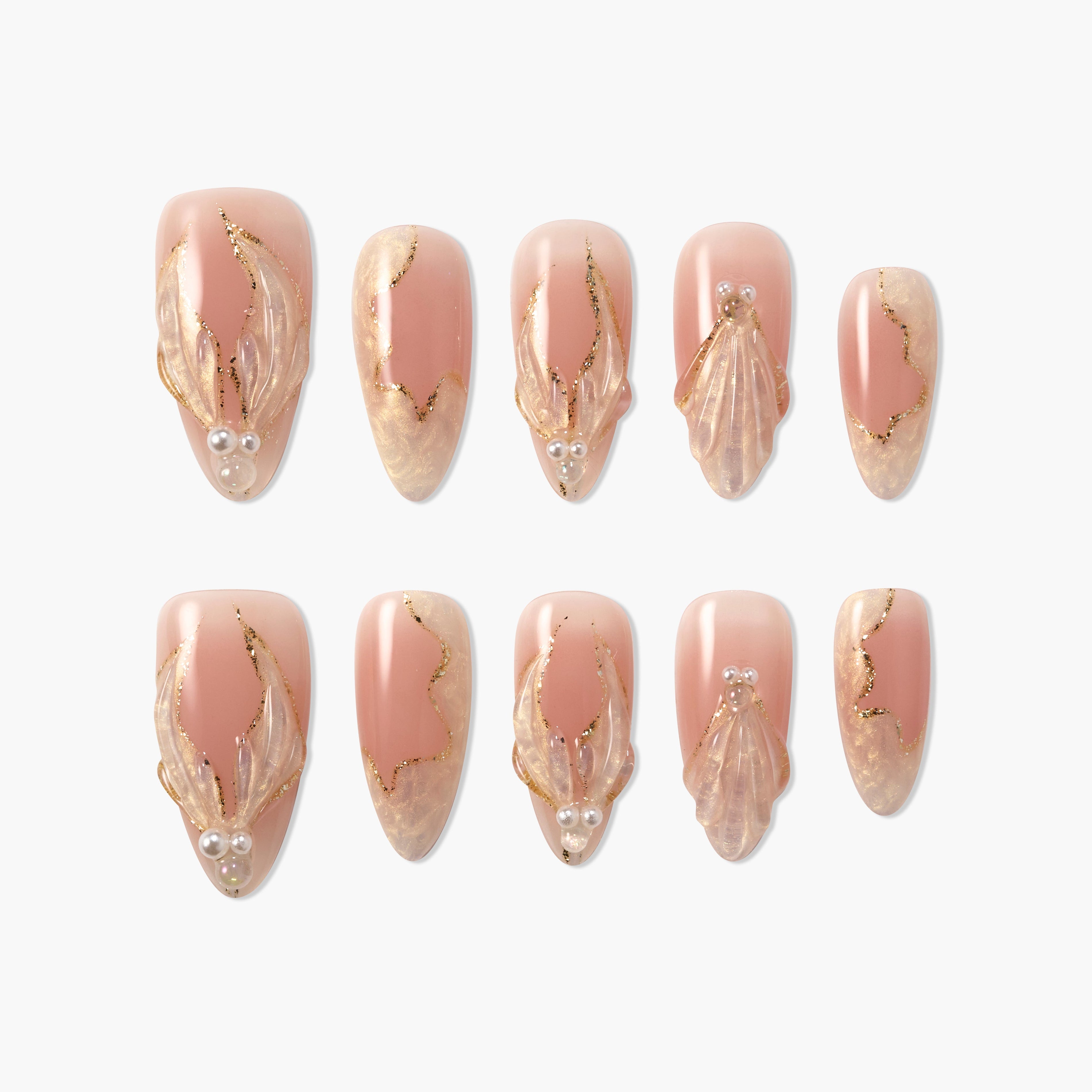 Set of nude pink press-on nails with gold glitter accents and translucent 3D leaf designs with pearl embellishments