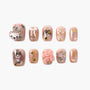 Set of pink glossy press-on nails with 3D cat designs, bows, pearls, and gold star accents