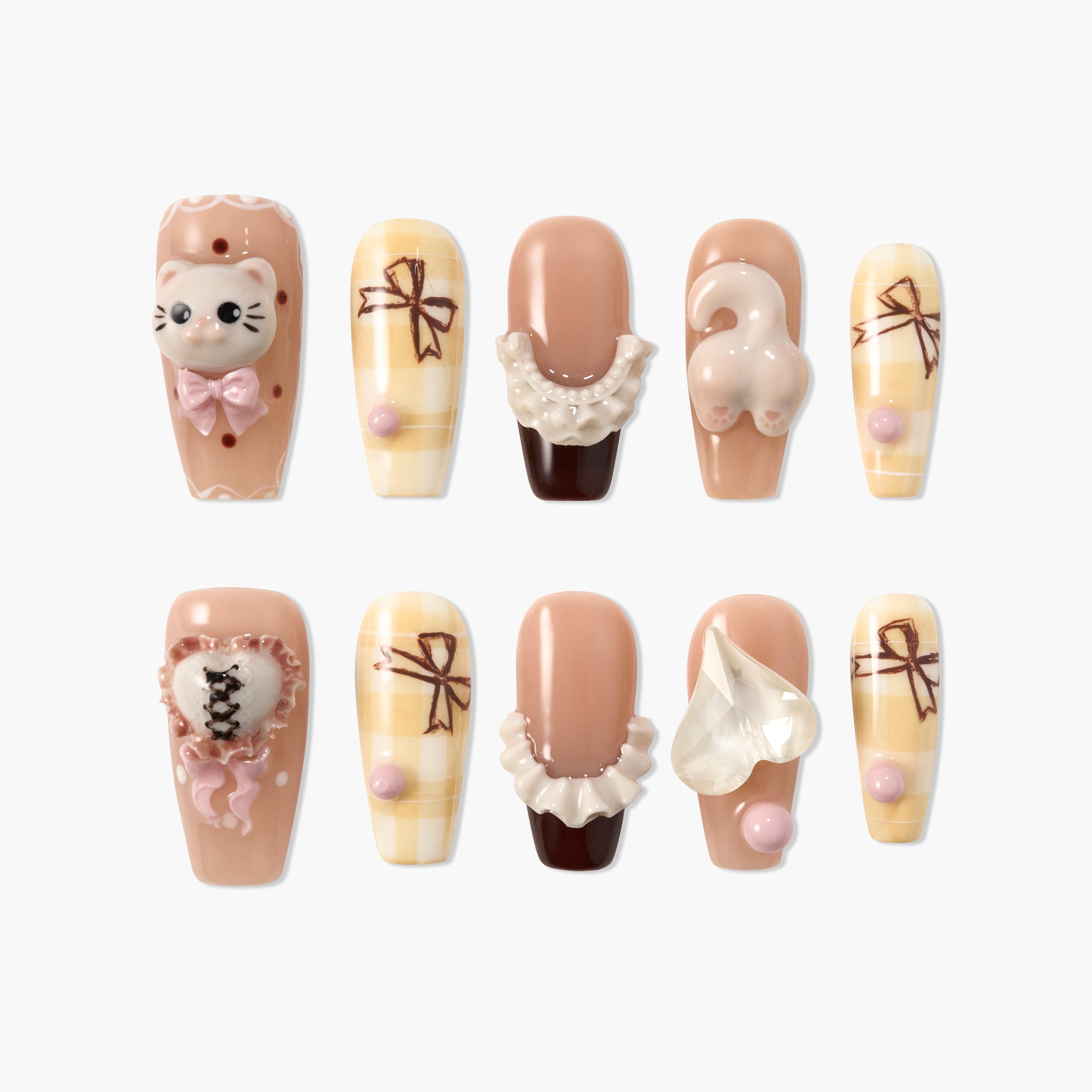 Cute press-on nails with 3D cat face, cat tail, heart, bows, and frilly ruffle details in beige and cream