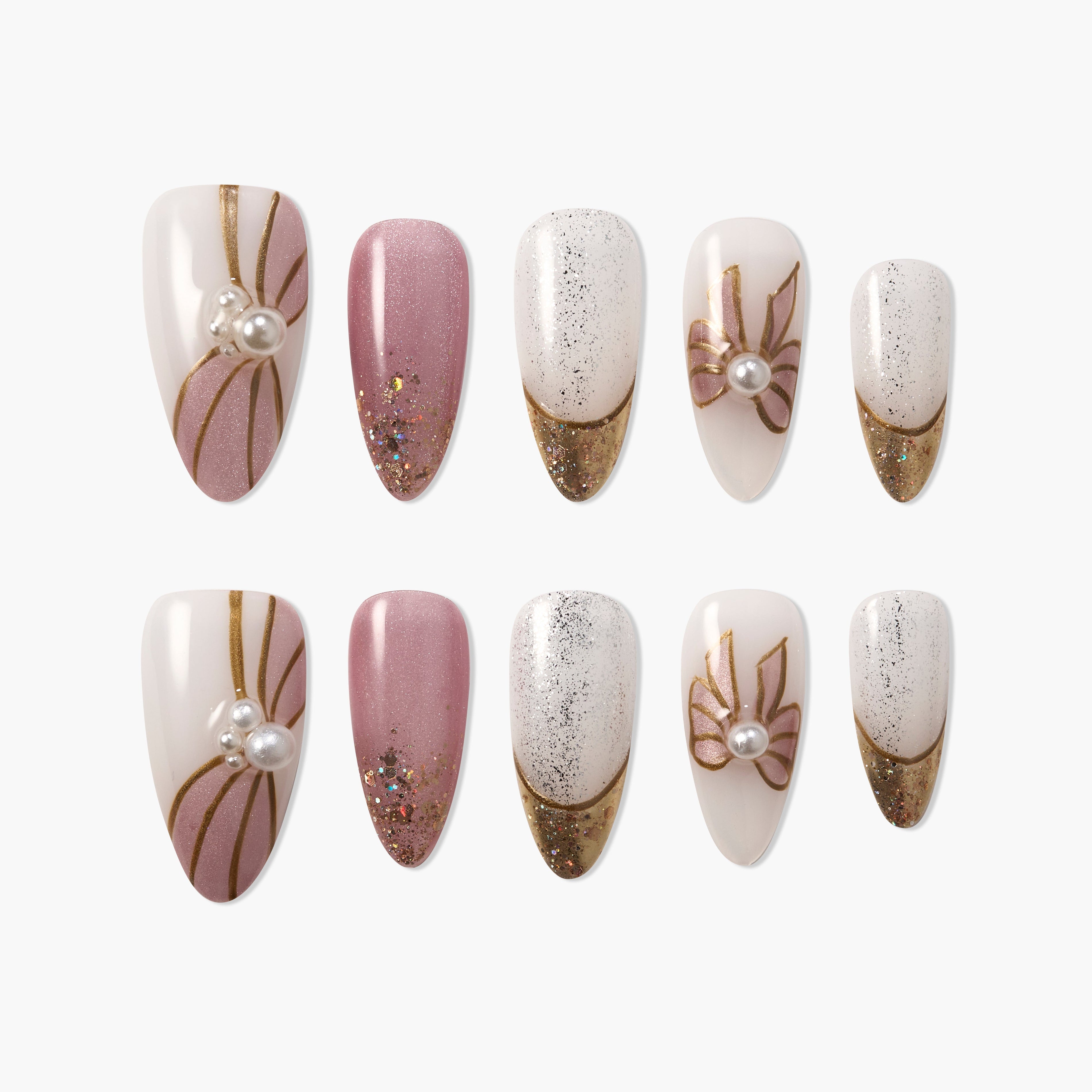 Set of elegant pink and white press-on nails with gold accents, glitter, and pearl decorations