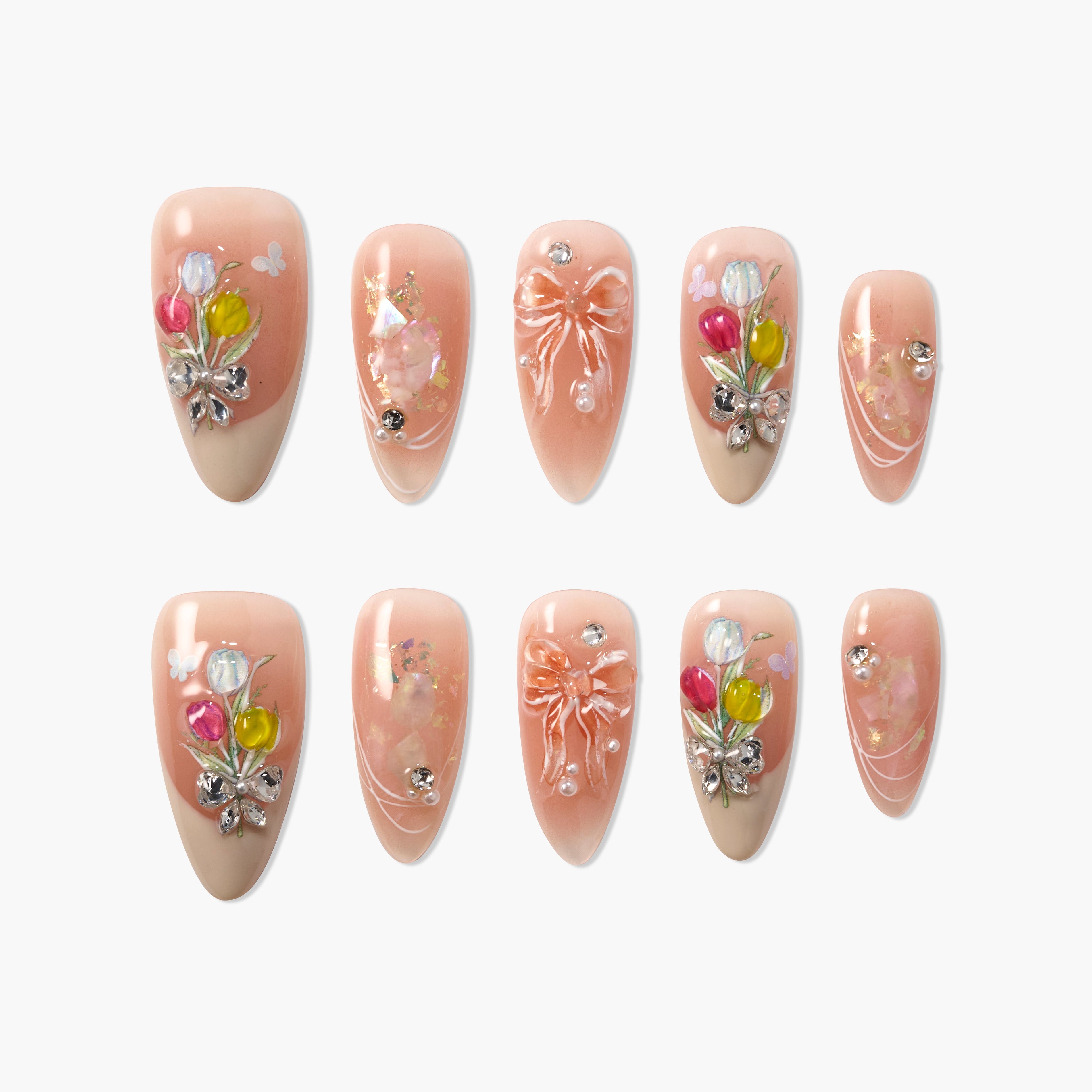 Set of peach nude press on nails with floral art, 3D bows, rhinestones, and glitter accents