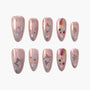 Handmade press-on nails with pink base, star glitter, and colorful star accents