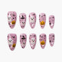 Halloween-themed press on nails with pink base, ghosts, pumpkins, witch hats, and black dots