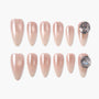 Set of pearlescent nude press-on nails with large rhinestone accents on two nails