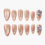 Set of nude press-on nails with glossy finish and decorated accent nails featuring large rhinestones and gold stars