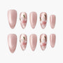 Glossy pink handmade press-on nails with 3D white floral and green leaf accents