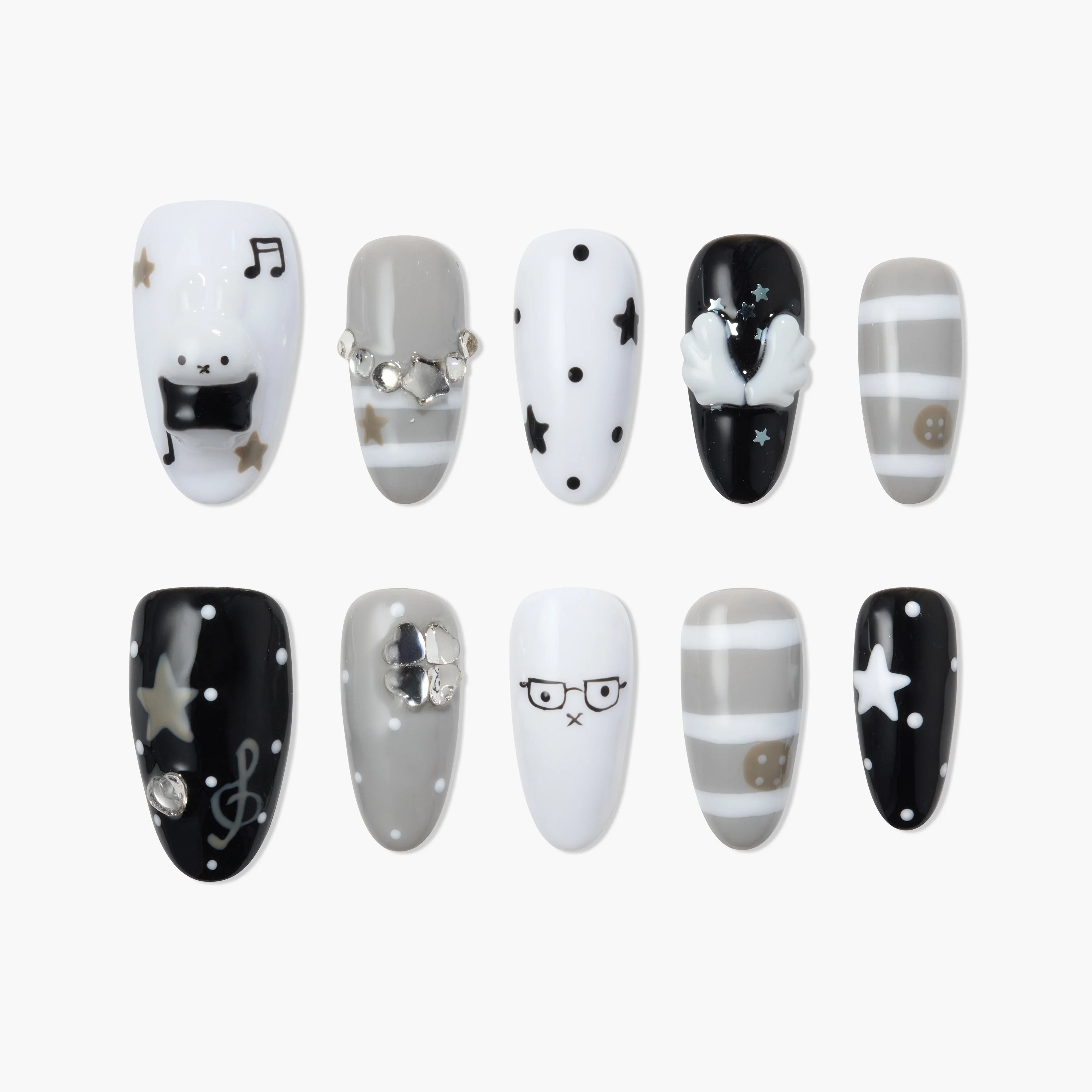 Handmade press-on nails in black, white, and grey with star, stripe, and cute bear designs.
