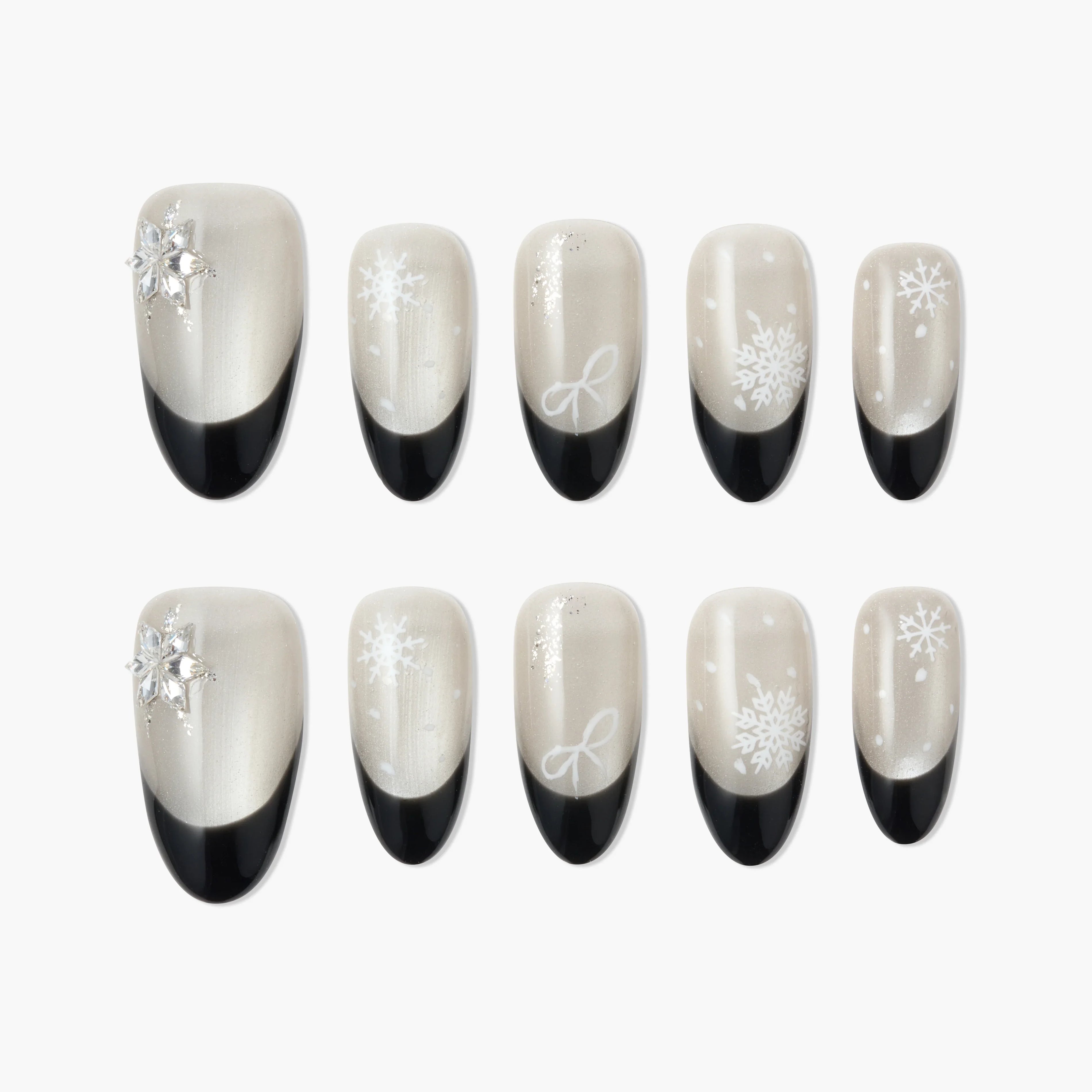 Handmade press-on nails with black French tips and white snowflake designs, winter nail art.