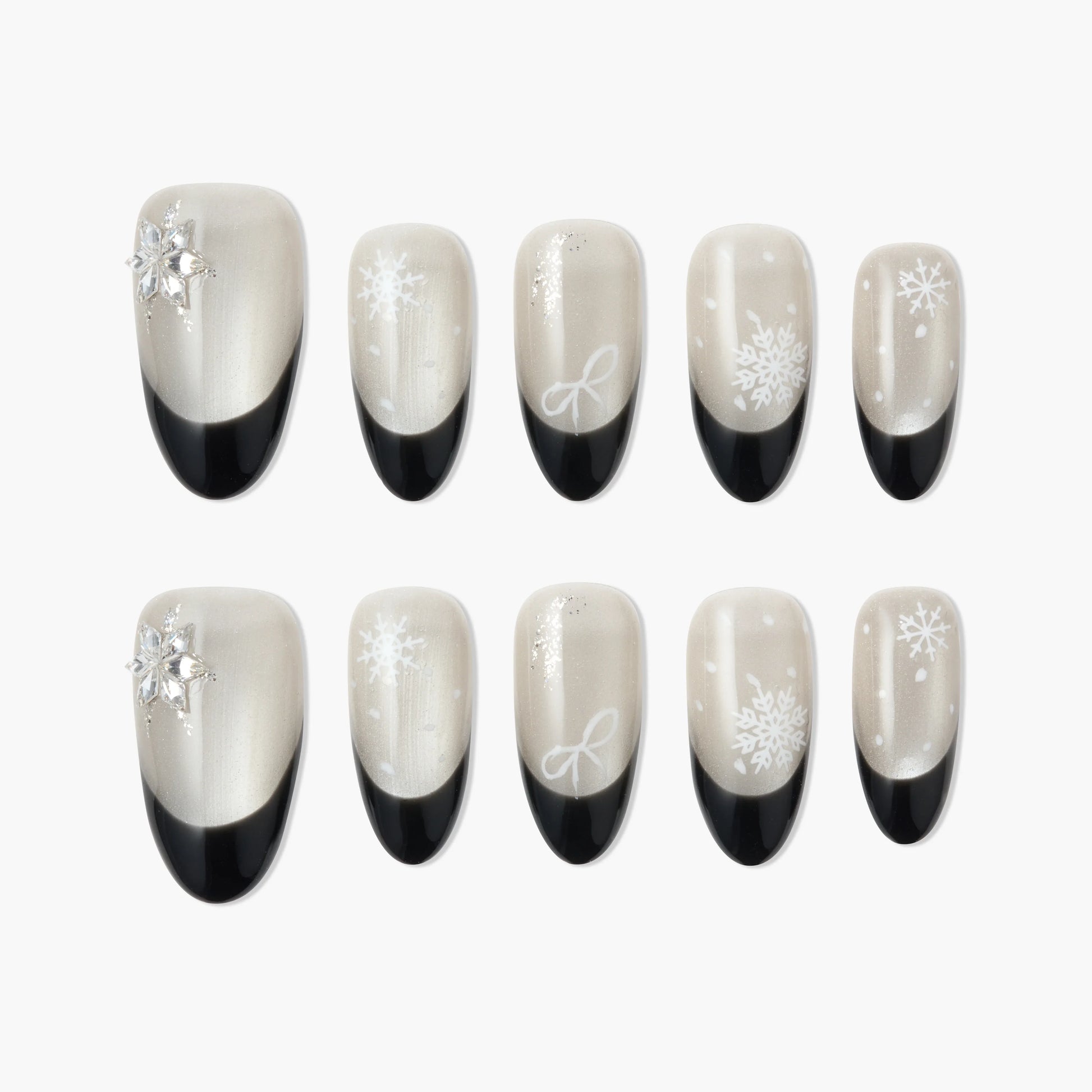 Handmade press-on nails with black French tips and white snowflake designs, winter nail art.