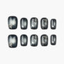Black and silver press-on nails with 3D star accents and rhinestone details, set of ten.