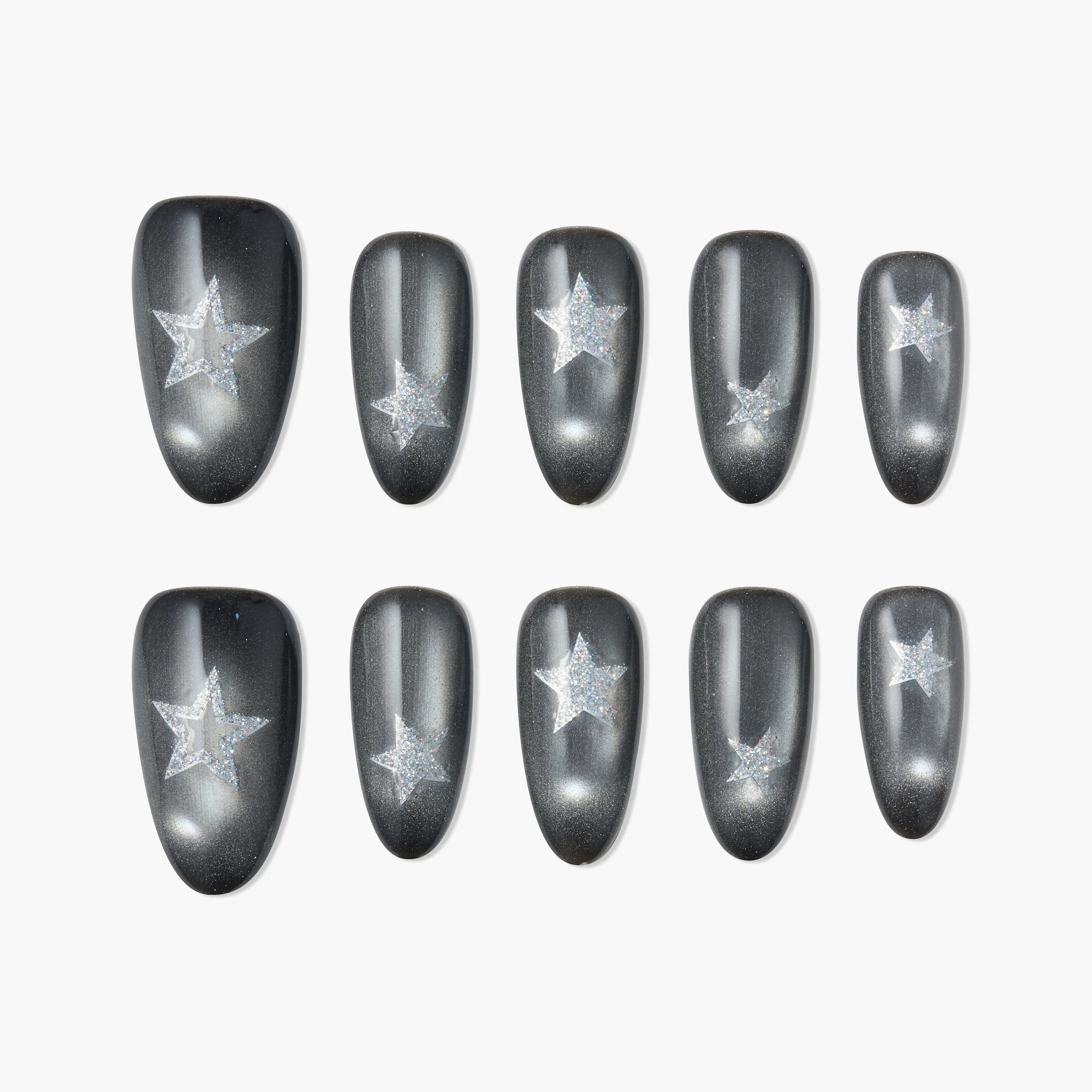 Glossy black press-on nails with glittery silver star design, displayed on white background.