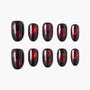 Black and red press-on nails with red rose designs and glossy finish, displayed on white background.
