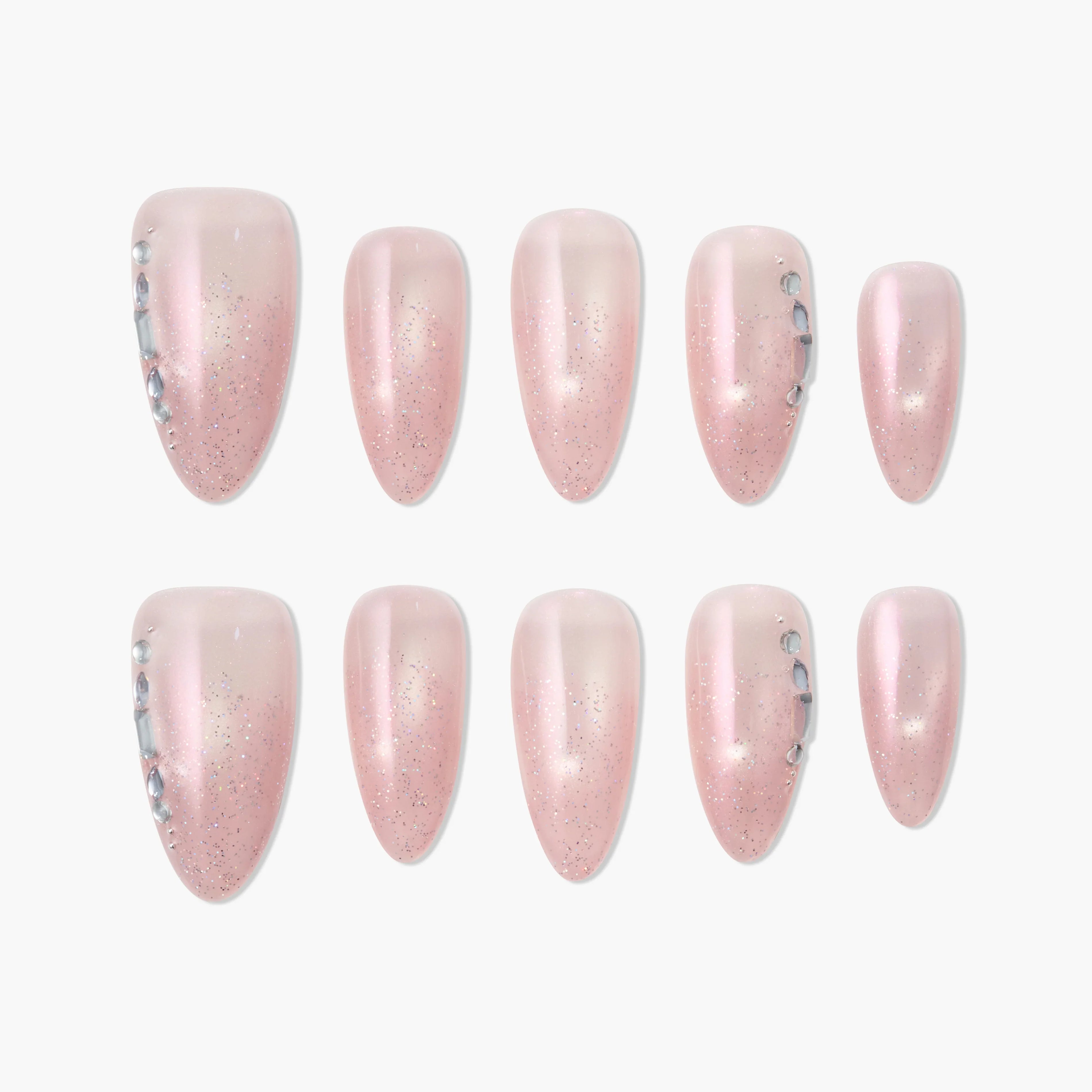 Handmade pink press-on nails with glitter and rhinestone accents, displayed on white background.