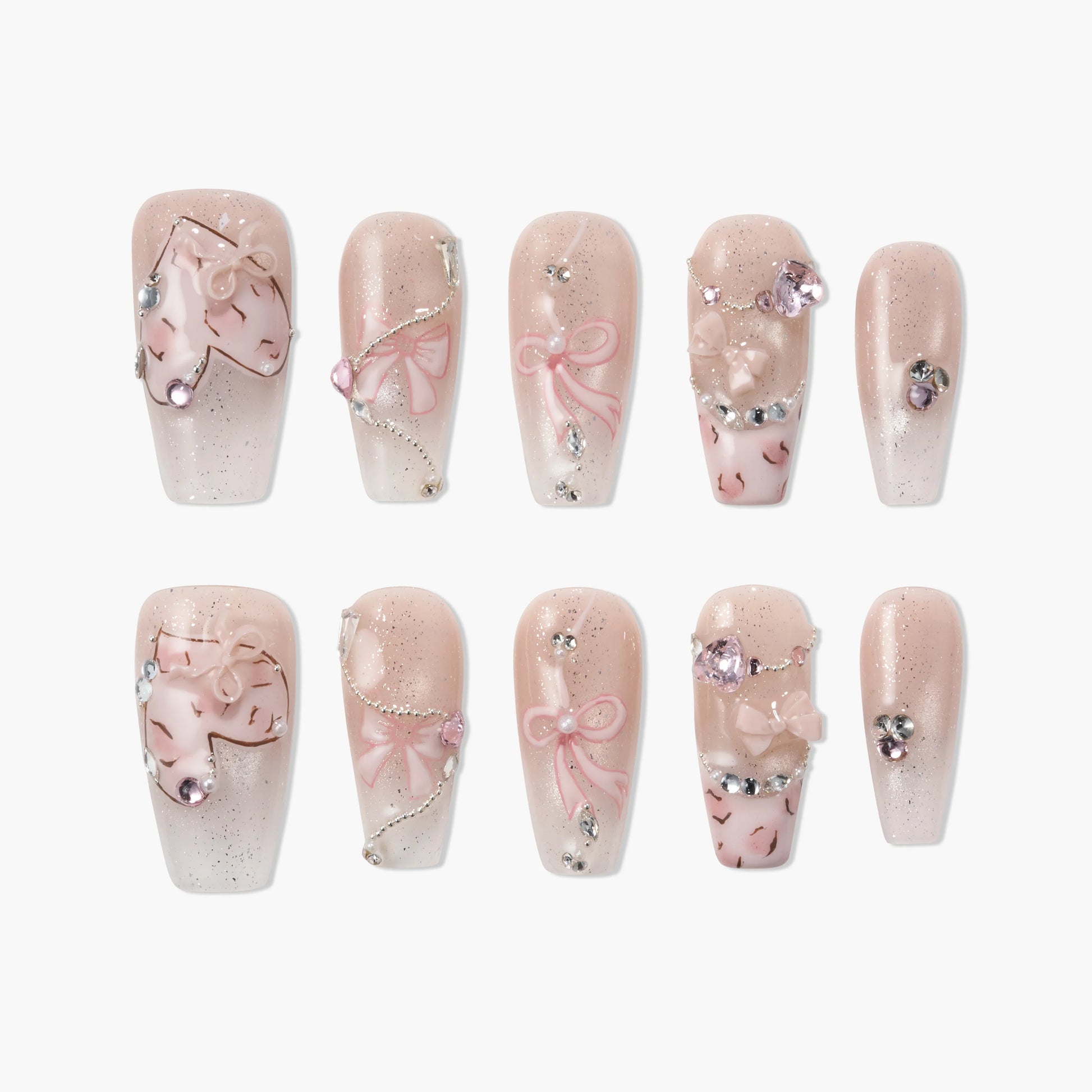 Handmade press-on nails with pink bows, 3D hearts, gems, and glitter accents on a nude base.