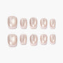 Set of glossy nude press-on nails with a subtle shimmer, arranged on white background