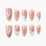 Handmade press-on nails with floral designs, butterfly art, and pearl accents on nude base