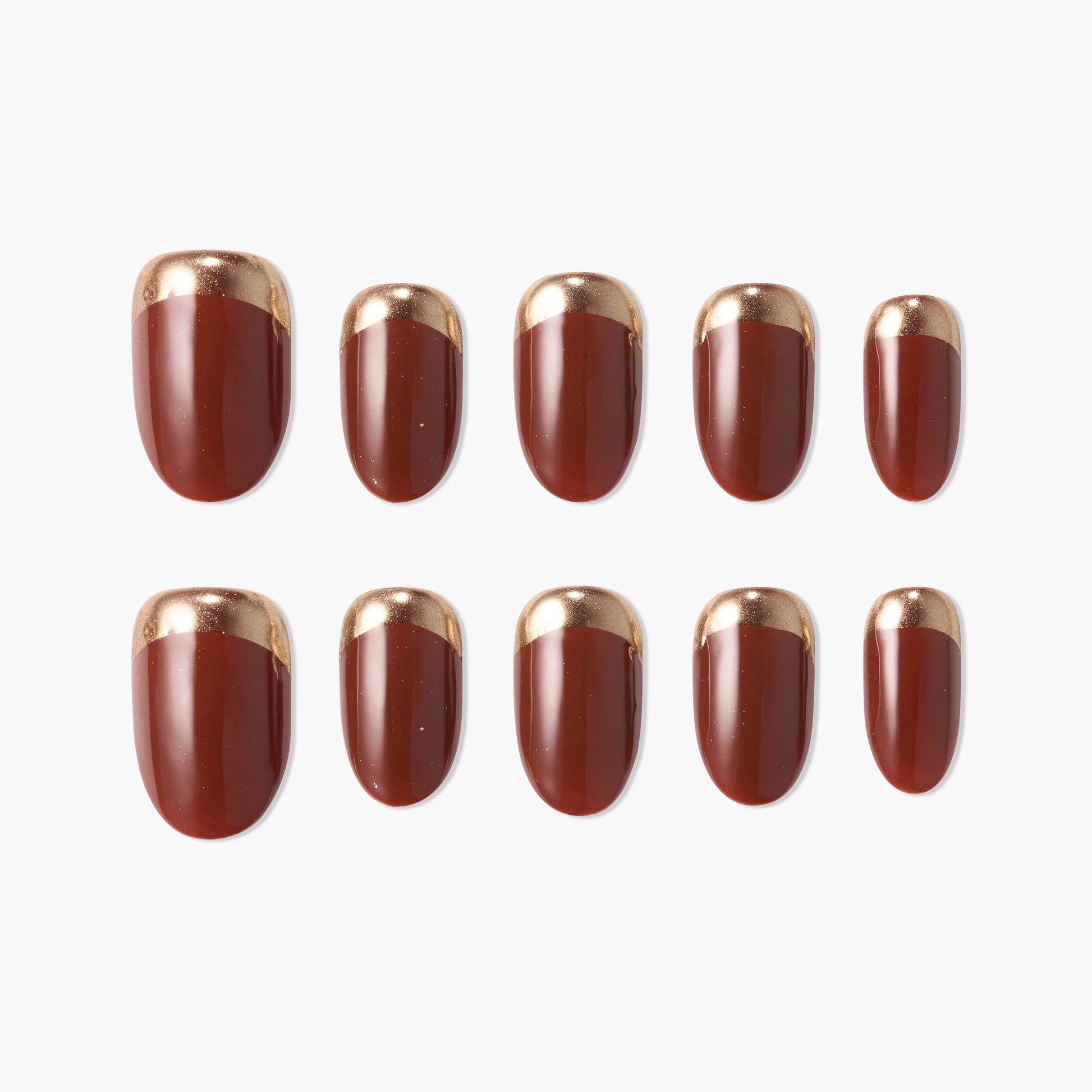 Set of press-on nails in glossy burgundy with metallic gold French tips on white background.