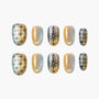 Handmade press-on nails in gold with geometric and floral designs, iridescent shimmer finish
