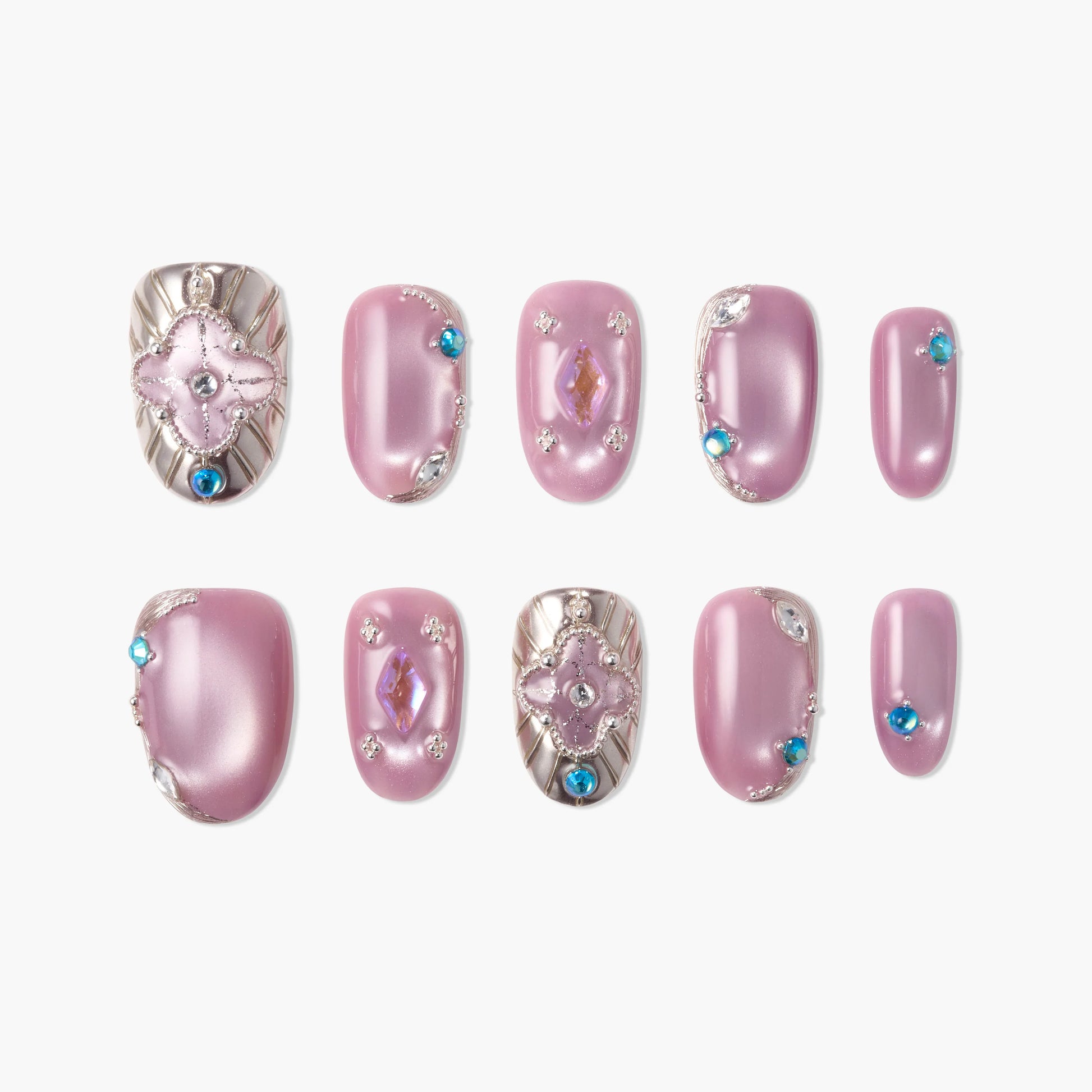Set of pink press-on nails with silver accents, gemstones, and intricate 3D nail art designs.