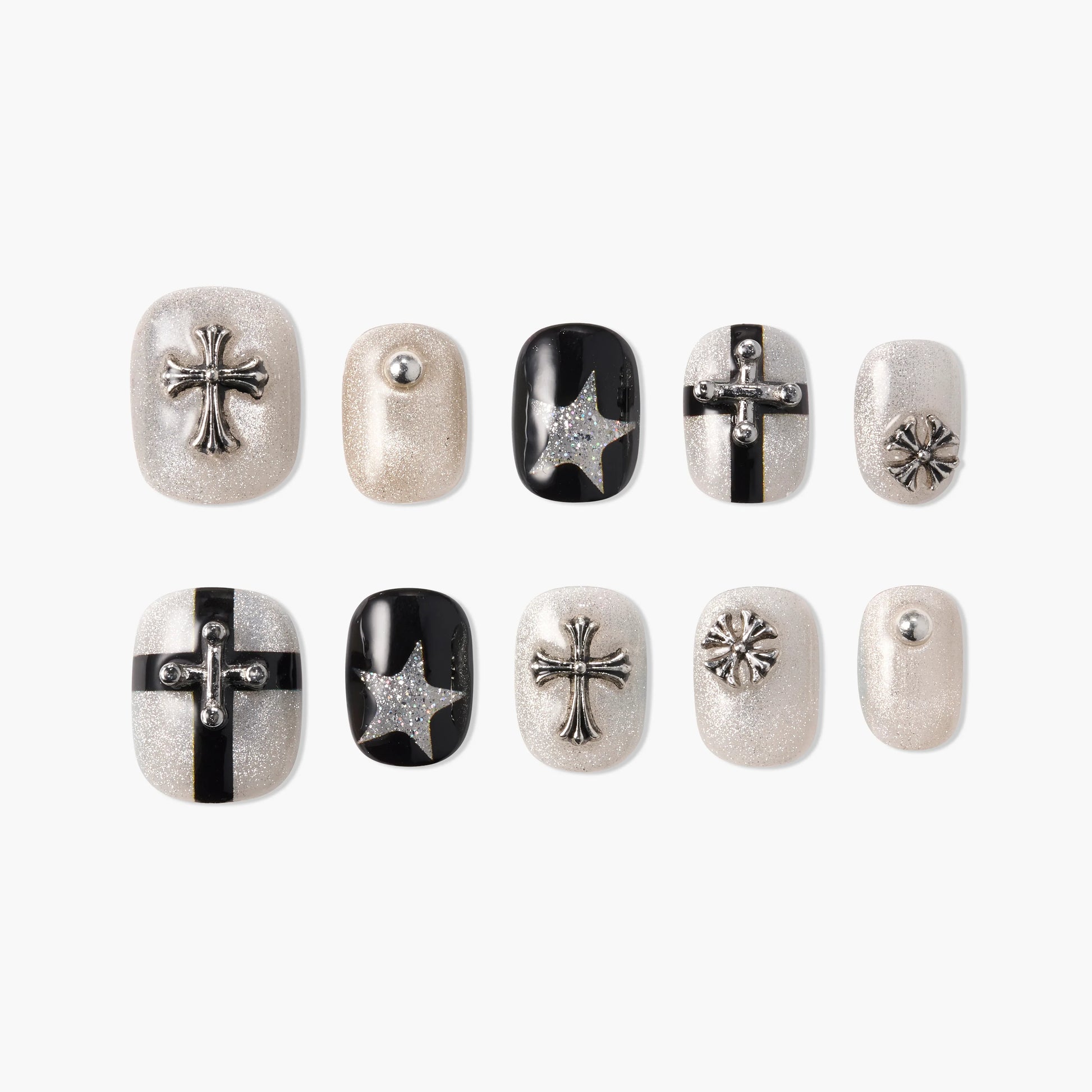 Glitter press-on nails set with silver cross, star, and stud accents in black and pearl tones