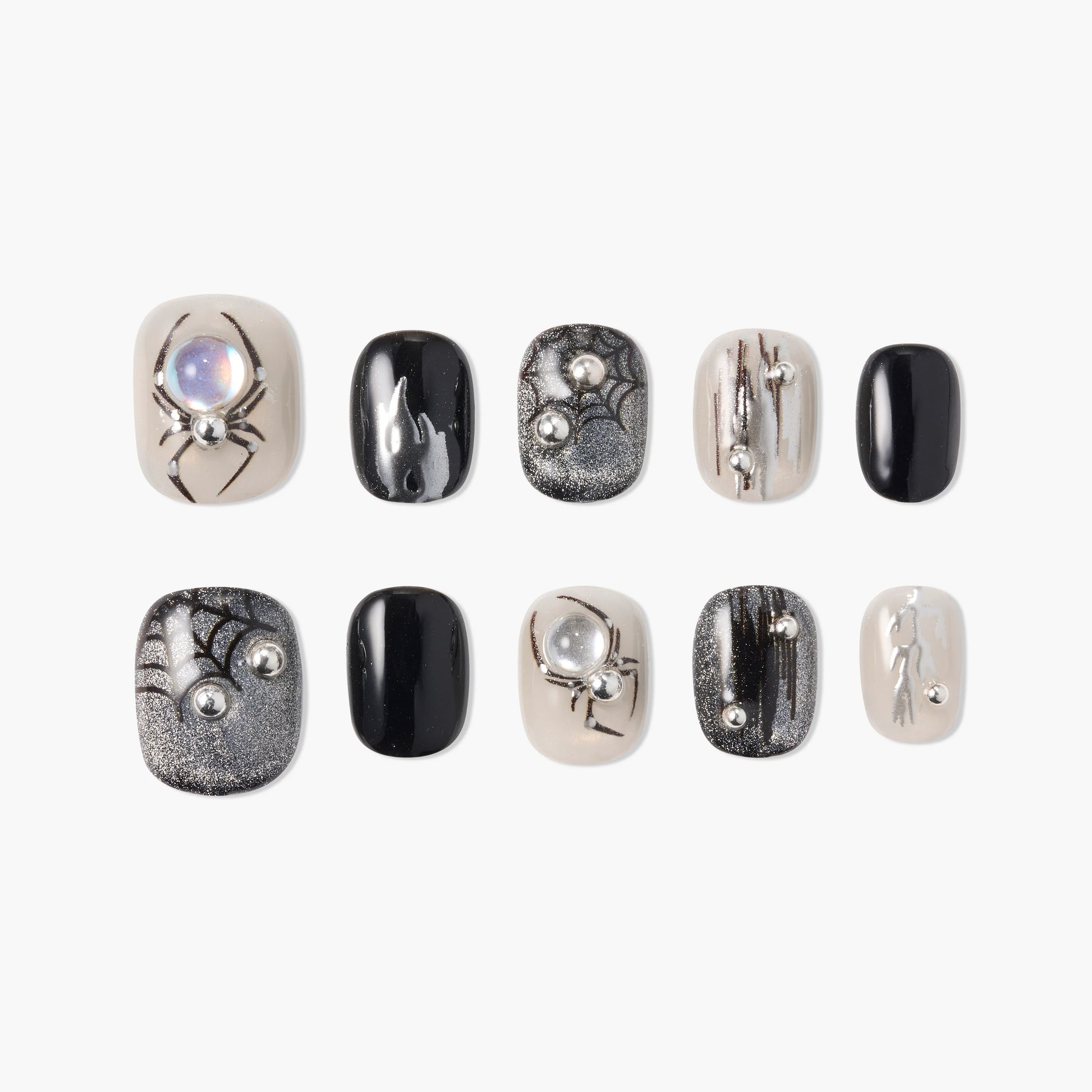 Handmade press-on nails with black, silver, and nude spider web and pearl accents.
