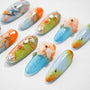 Handmade press-on nails with blue, orange, and green ombre designs, 3D floral accents, and rhinestones