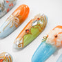 Handmade press-on nails with orange, blue, and green designs, jeweled accents, and floral details.