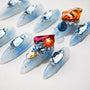 Light blue press-on nails with large rhinestone gems and glitter accents